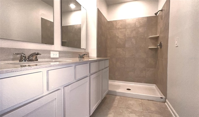 bathroom featuring tiled shower, vanity, and backsplash