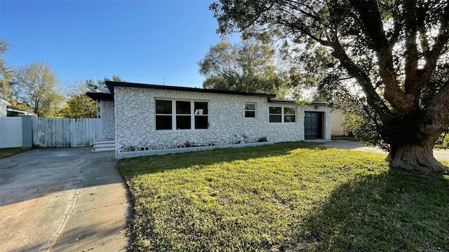 ranch-style home with a garage and a front yard