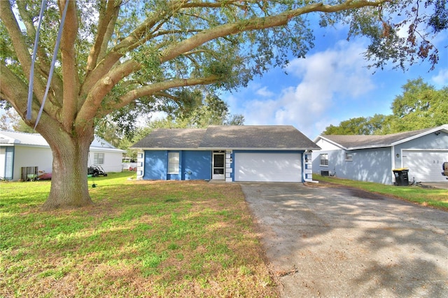 single story home featuring a garage and a front yard