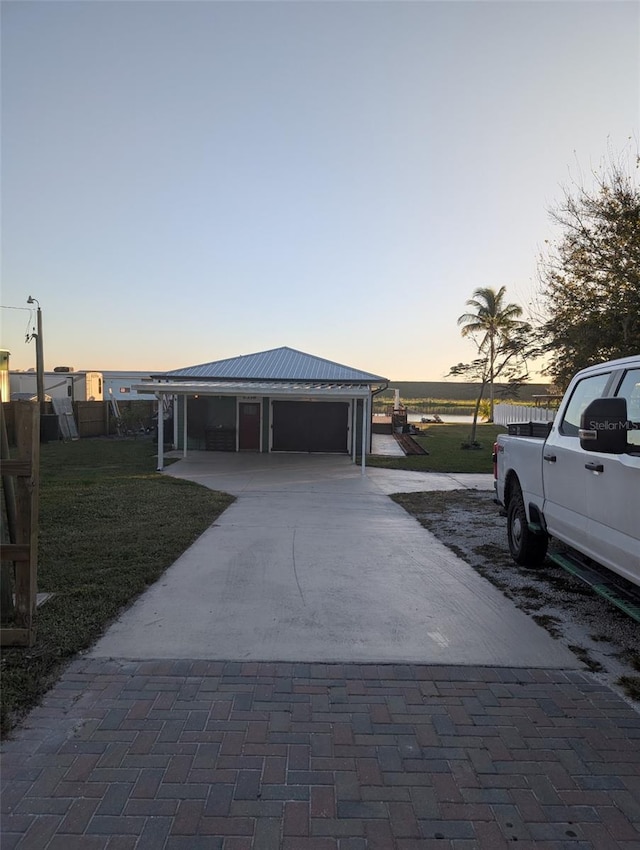 view of front facade featuring a lawn and a carport