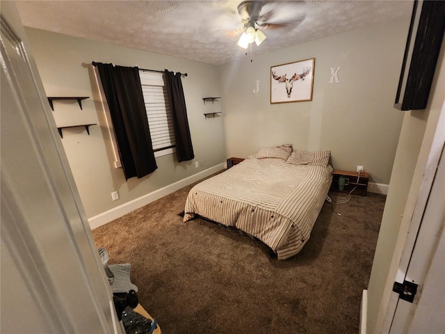 bedroom with ceiling fan, dark colored carpet, and a textured ceiling