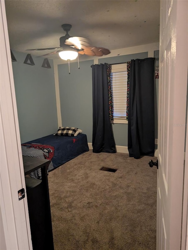 bedroom with ceiling fan and carpet floors