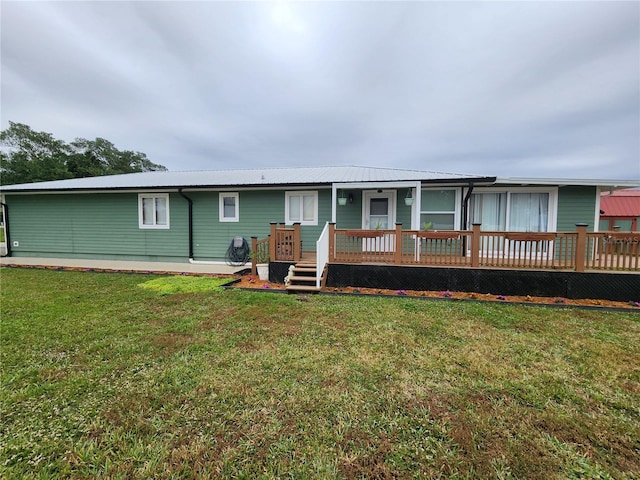 view of front of home featuring a front yard and a deck