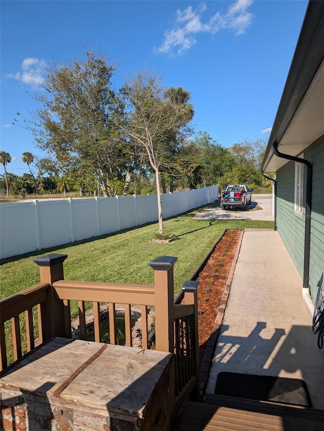 wooden deck featuring a yard