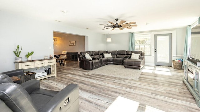 living room featuring light wood-type flooring and ceiling fan