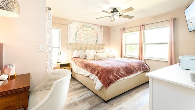 bedroom with light hardwood / wood-style flooring and ceiling fan