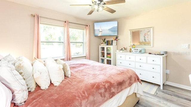 bedroom featuring light hardwood / wood-style floors and ceiling fan