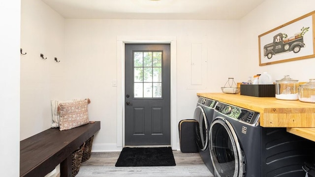 laundry room featuring washer and clothes dryer and wood-type flooring