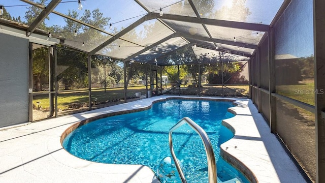 view of pool featuring a patio area and a lanai