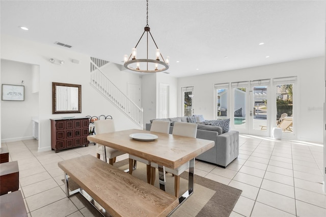 tiled dining area featuring a notable chandelier