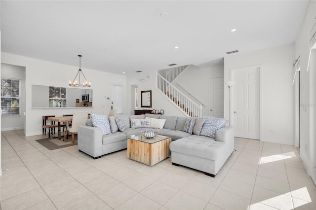 tiled living room with an inviting chandelier