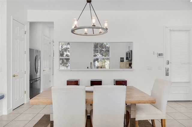 dining room featuring light tile patterned floors and a notable chandelier