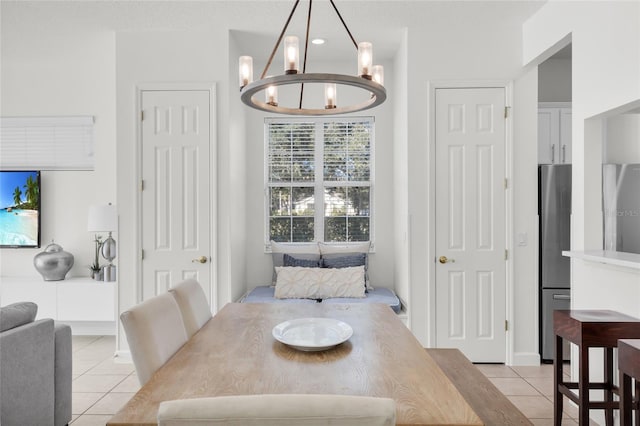 dining room with a chandelier and light tile patterned floors