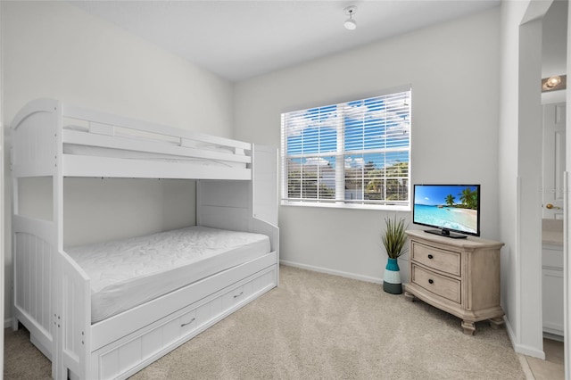 bedroom featuring light colored carpet