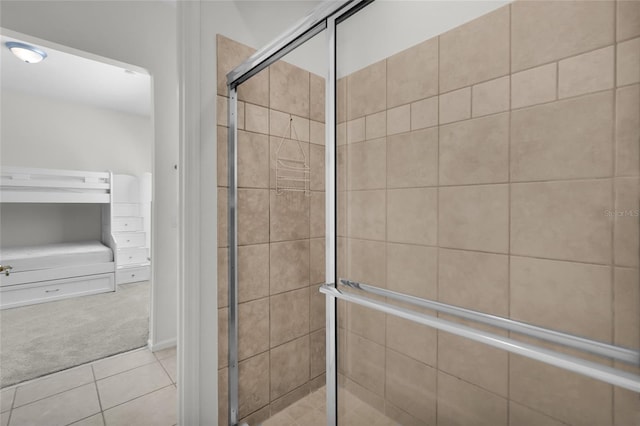 bathroom with tile patterned flooring and a shower with shower door