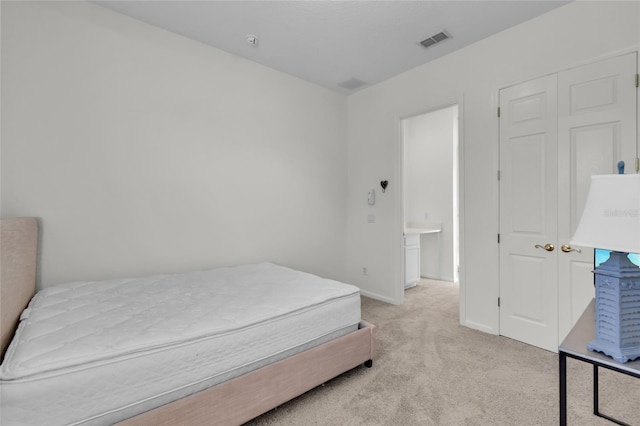 carpeted bedroom with a closet