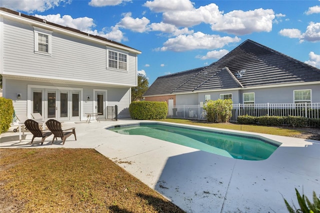 view of pool with a patio and french doors