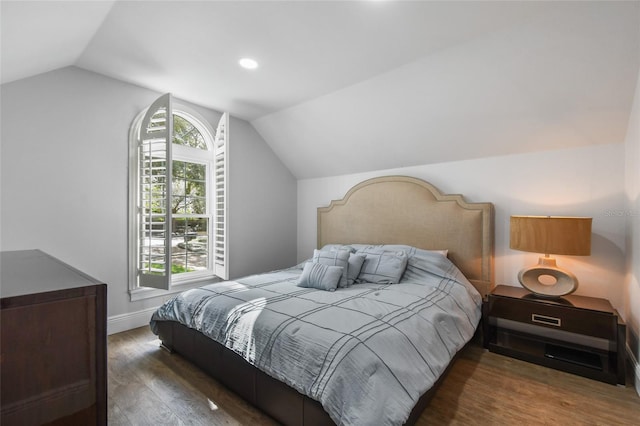 bedroom with dark hardwood / wood-style floors and vaulted ceiling