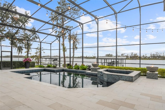 view of pool featuring a water view, an in ground hot tub, a lanai, and a patio area