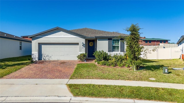 single story home featuring a garage and a front lawn