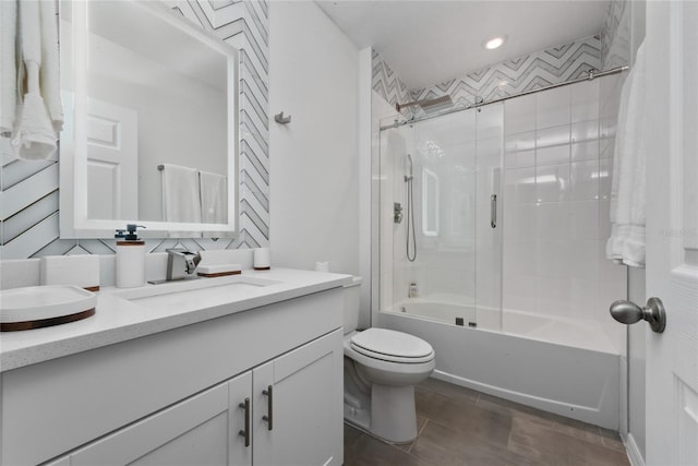 full bathroom featuring vanity, toilet, tiled shower / bath, and backsplash