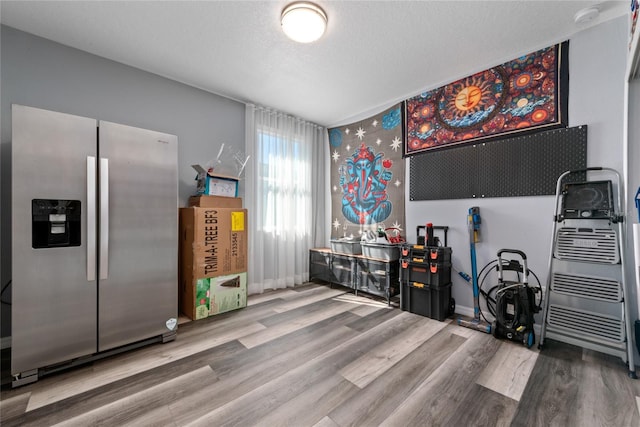 miscellaneous room with wood-type flooring and a textured ceiling