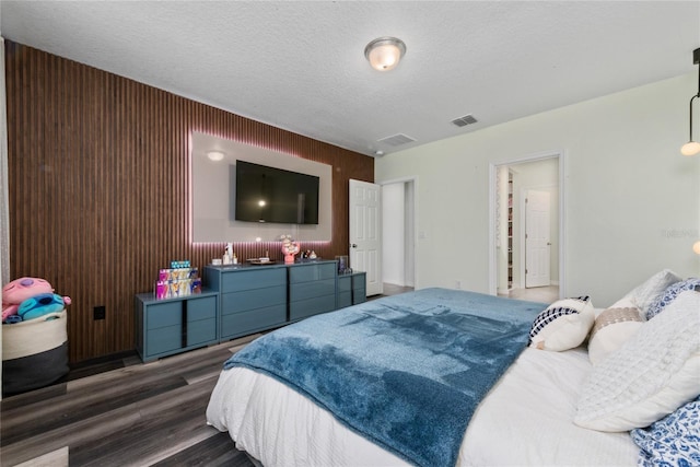 bedroom with dark wood-type flooring and a textured ceiling