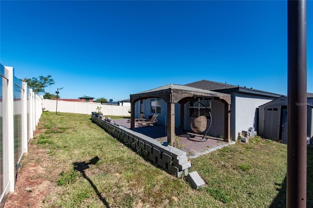 view of yard with a patio area and a storage unit