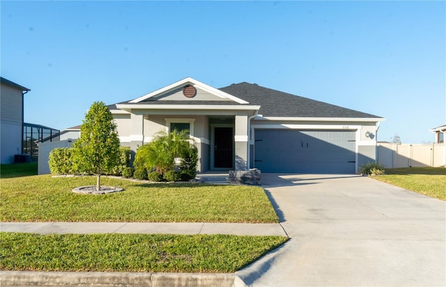 view of front of house featuring a garage and a front lawn