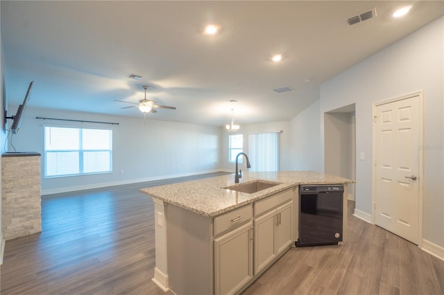 kitchen with a wealth of natural light, sink, a center island with sink, and black dishwasher