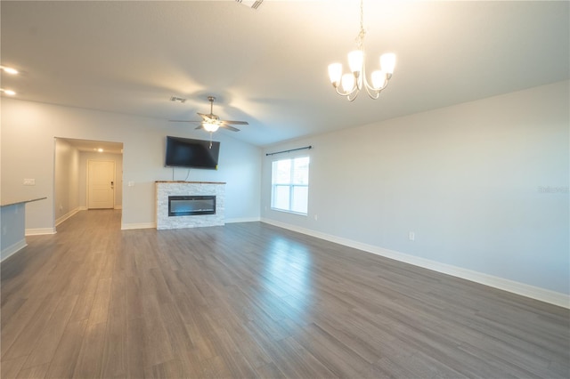 unfurnished living room with a fireplace, dark hardwood / wood-style flooring, and ceiling fan with notable chandelier