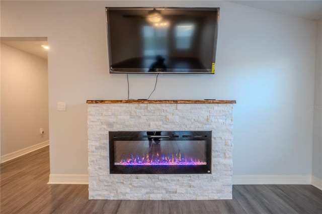 room details with hardwood / wood-style floors and a fireplace