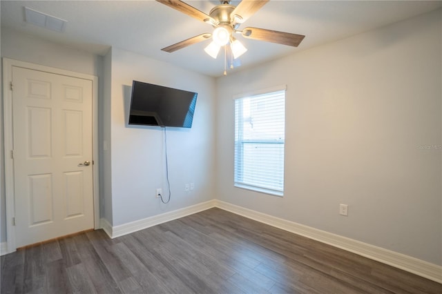 unfurnished bedroom featuring ceiling fan and dark wood-type flooring