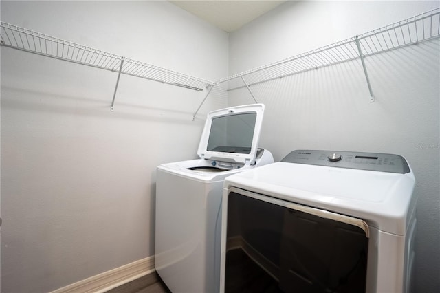 washroom with hardwood / wood-style flooring and independent washer and dryer