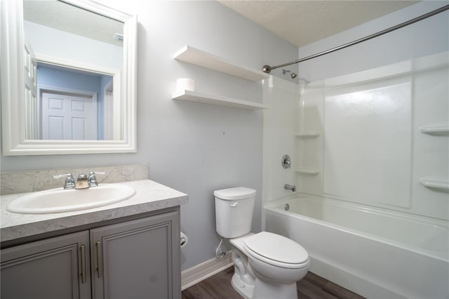 full bathroom with a textured ceiling, vanity, hardwood / wood-style flooring, and toilet