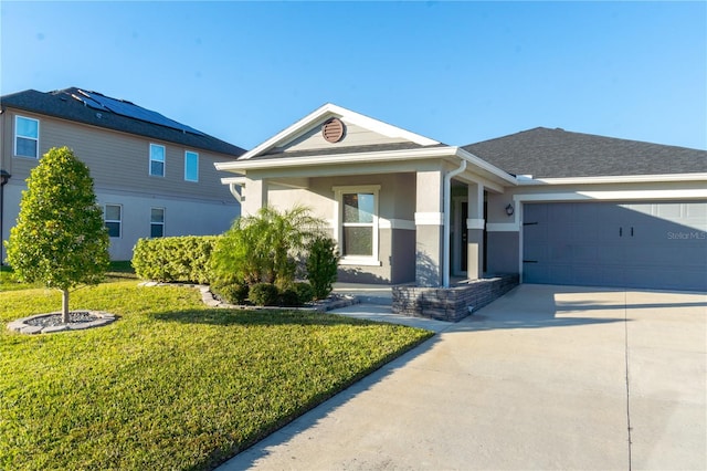 view of front of home with a garage and a front lawn