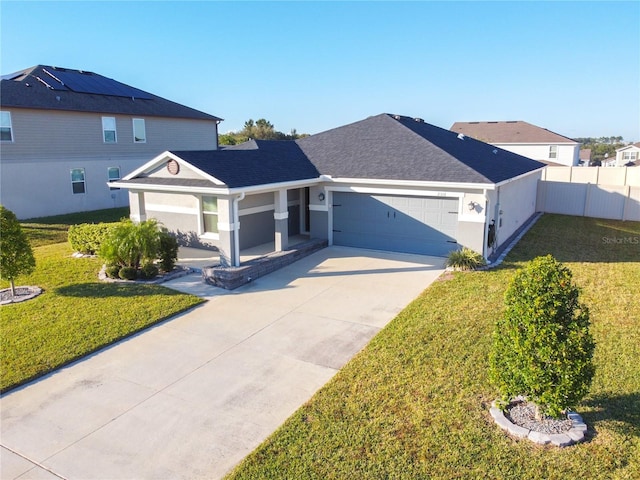 view of front of property featuring a front lawn and a garage