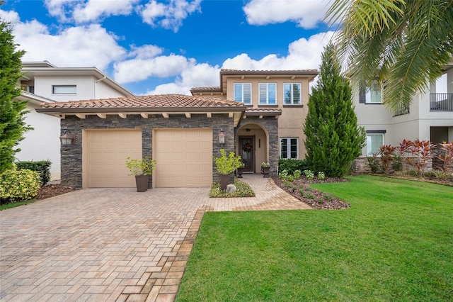 mediterranean / spanish-style home featuring a garage and a front yard