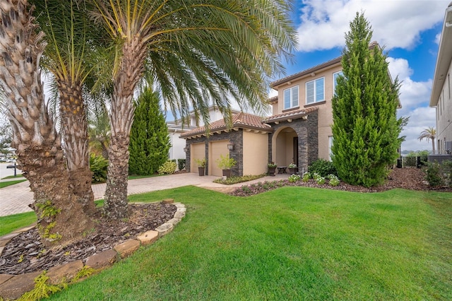 view of front of property featuring a front yard and a garage