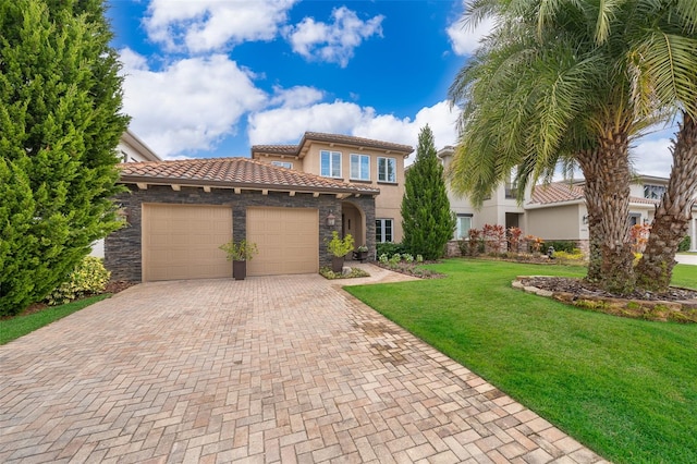 mediterranean / spanish home featuring a front yard and a garage