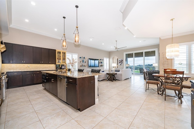 kitchen featuring dark brown cabinetry, a center island with sink, pendant lighting, and ceiling fan with notable chandelier