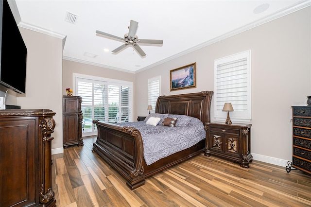 bedroom with light hardwood / wood-style flooring, ceiling fan, and ornamental molding