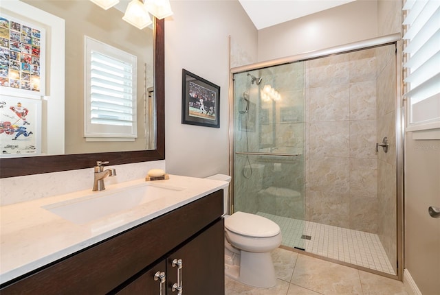 bathroom with tile patterned flooring, vanity, toilet, and walk in shower