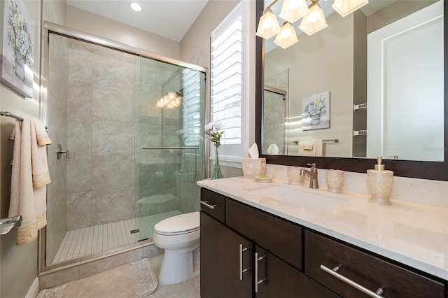 bathroom featuring tile patterned floors, vanity, toilet, and an enclosed shower