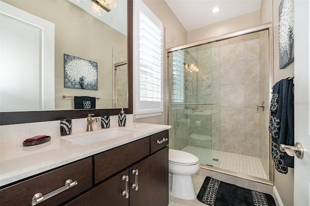 bathroom with tile patterned flooring, vanity, toilet, and a shower with shower door