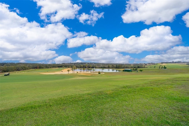 view of community featuring a lawn and a water view