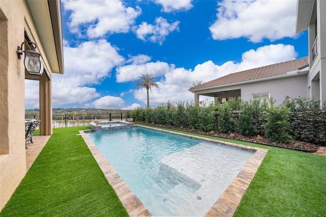 view of swimming pool featuring a lawn, an in ground hot tub, and a water view