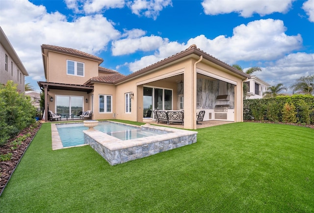 rear view of house with ceiling fan, a yard, an outdoor kitchen, a fenced in pool, and a patio