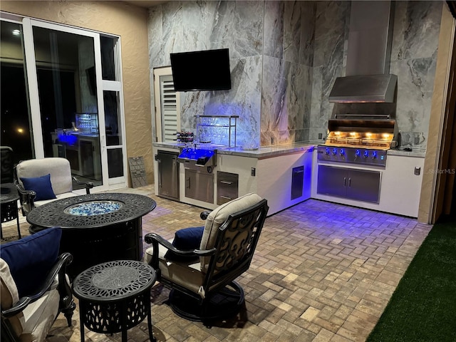 view of patio with area for grilling and a grill