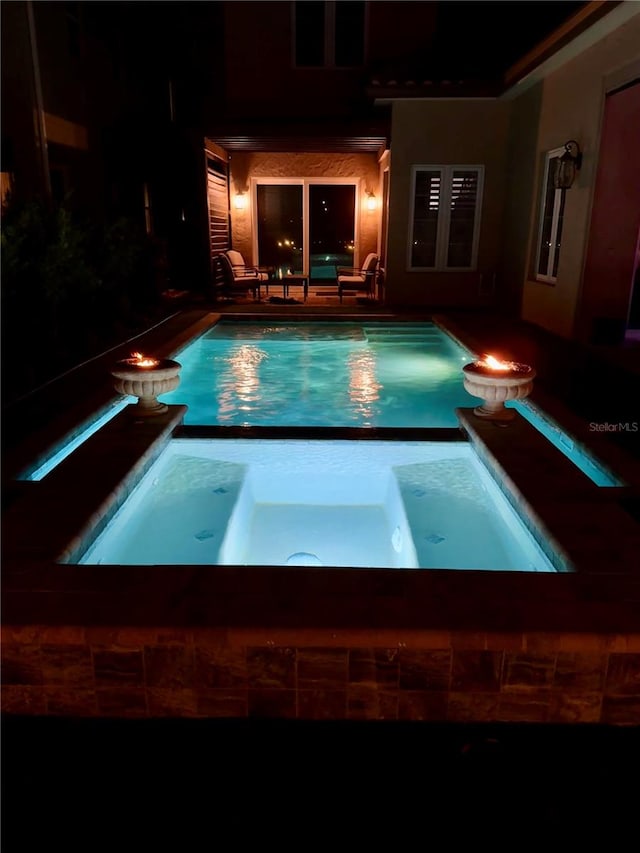 view of swimming pool featuring a patio area, an in ground hot tub, and an outdoor living space